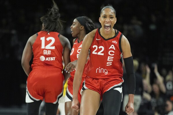 Las Vegas Aces center A'ja Wilson (22) celebrates after a play against the Los Angeles Sparks during the first half of a WNBA basketball game Friday, May 30, 2025, in Las Vegas. (AP Photo/John Locher)