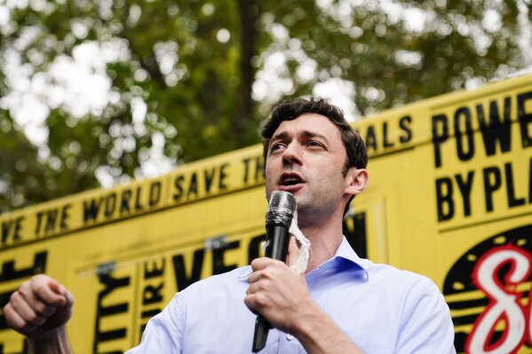Democratic candidate for Senate Jon Ossoff speaks to a crowd during a "Get Out the Early Vote" event at the SluttyVegan ATL restaurant on Tuesday, Oct. 27, 2020, in Jonesboro, Ga. (AP Photo/Brynn Anderson)