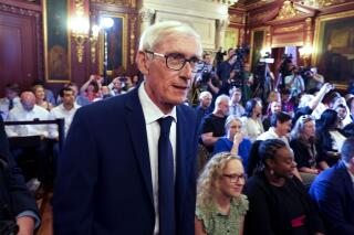 FILE - In this July 3, 2019, file photo, Wisconsin Gov. Tony Evers arrives to sign the budget at the State Capitol in Madison. How much and what taxes to cut is one of the largest remaining questions for the Legislature's budget-writing committee to tackle this week as it nears the end of its work writing the state budget. The Republican-controlled panel hopes to complete its work on Thursday, June 17, 2021. (Steve Apps/Wisconsin State Journal via AP, File)