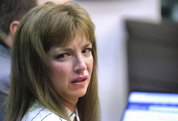 Danielle Redlick, acquitted of murdering her husband in their Winter Park, Fla., home in 2019, sobs as a victims' statement is read during her sentencing hearing in Orange circuit court in Orlando, Fla., Friday, Aug. 5. 2022. Redlick was convicted of tampering with evidence in the stabbing death of her spouse, University of Central Florida executive Michael Redlick. Redlick was sentenced Friday to a year of probation on an evidence tampering charge. (Joe Burbank/Orlando Sentinel via AP)
