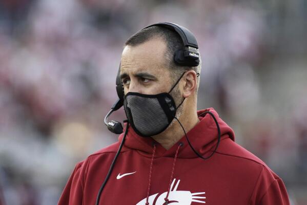 FILE - Washington State coach Nick Rolovich watches during the first half of an NCAA college football game against Stanford on Oct. 16, 2021, in Pullman, Wash. Rolovich has sued the university and Gov. Jay Inslee after he was fired last year for refusing to get vaccinated against COVID-19. (AP Photo/Young Kwak, File)