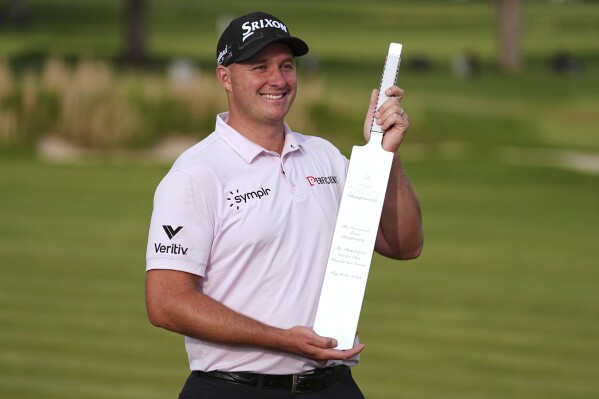 Sepp Straka, of Austria, poses with the trophy after winning the Truist Championship golf tournament at the Philadelphia Cricket Club, Sunday, May 11, 2025, in Flourtown. (AP Photo/Matt Rourke)