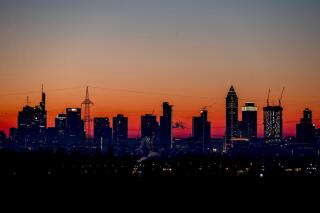 FILE - In this Feb.14, 2021 file photo the sun is about to rise behind the buildings of the banking district in Frankfurt, Germany. The European statistics agency Eurostat released monthly inflation figures Tuesday.(AP Photo/Michael Probst, file)