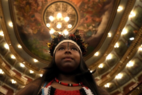 Maira Tembe stands inside Teatro da Paz before the start of a ceremony to present Brazil's national Indigenous census in Belem, Brazil, Monday, Aug. 7, 2023. Belem will host the Amazon Summit, a meeting by the nations that are part of the Amazon Cooperation Treaty: Brazil, Bolivia, Colombia, Guyana, Ecuador, Peru, Suriname, Venezuela and French Guiana. (AP Photo/Eraldo Peres)