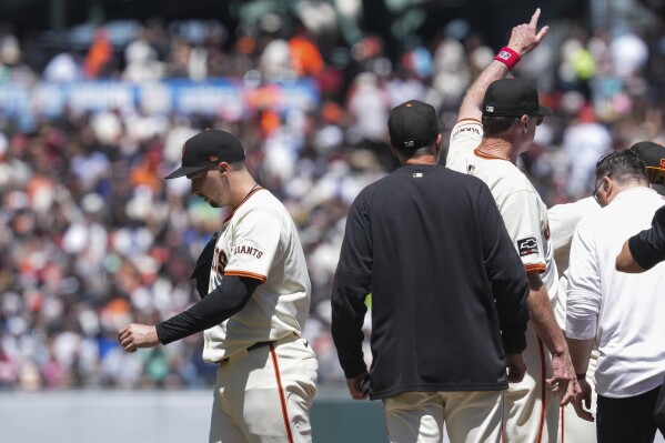 San Francisco Giants manager Bob Melvin, third from left, signals of the bullpen as pitcher Blake Snell, left, exits during the fifth inning of a baseball game against the New York Yankees, Sunday, June 2, 2024, in San Francisco. (AP Photo/Godofredo A. Vásquez)