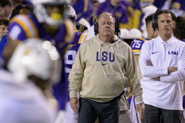 FILE - LSU head coach Brian Kelly, center, watches from the sideline during the second half of an NCAA college football game against Georgia State in Baton Rouge, La., Saturday, Nov. 18, 2023. (AP Photo/Matthew Hinton, File)