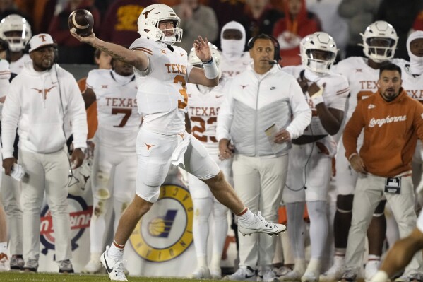 Texas quarterback Quinn Ewers (3) passes the ball on the fly during the first half of an NCAA college football game against Iowa State, Saturday, Nov. 18, 2023, in Ames, Iowa. (AP Photo/Matthew Putney)