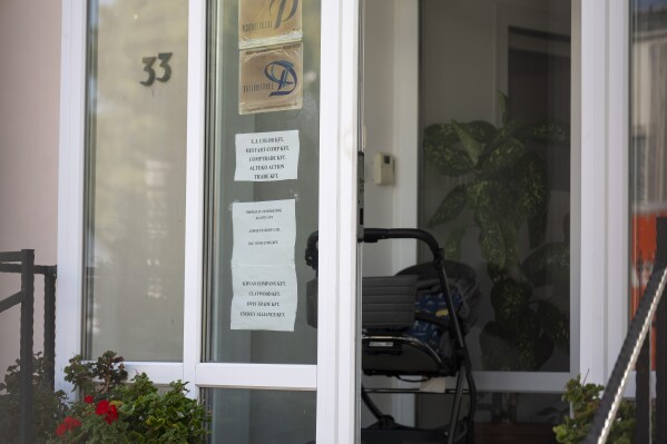 This shows a sign featuring the names of several companies on the door of a house where a Hungarian company that allegedly manufactured pagers that exploded in Lebanon and Syria is headquartered in Budapest on Wednesday, Sept. 18, 2024. (AP Photo/Denes Erdos)