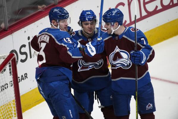 Colorado Avalanche right wing Valeri Nichushkin, left, celebrates his goal with defensemen Samuel Girard and Devon Toews, right, during the first period of an NHL hockey game against the Vancouver Canucks on Thursday, Nov. 11, 2021, in Denver. (AP Photo/David Zalubowski)
