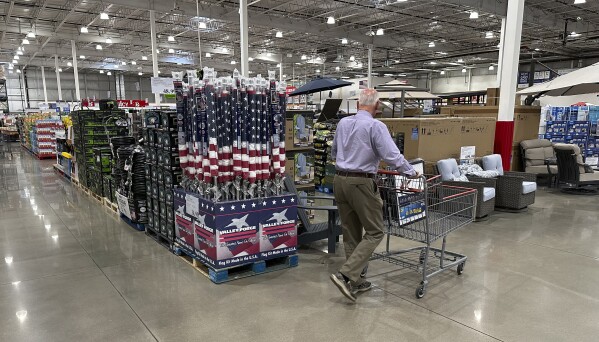 A shopper moves past a display of items in a Costco warehouse Saturday, May 18, 2024, in Sheridan, Colo. As many Americans celebrate Memorial Day on Monday, May 27, 2024, there are several stores, government offices and businesses that will be open or closed.(AP Photo/David Zalubowski)