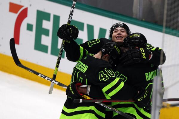 Dallas Stars left wing Jason Robertson, center Jacob Peterson (40), and right wing Alexander Radulov (47) celebrate a second-period goal against the Winnipeg Jets in an NHL hockey game Friday, Feb 11, 2022, in Dallas. (AP Photo/Richard W. Rodriguez)