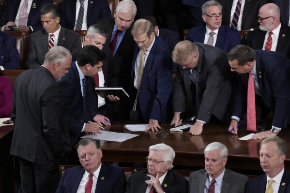 Rep. Jim Jordan, R-Ohio, stands and talks with Republican House Whip Rep. Tom Emmer, R-Minn., as they discuss the tally of the first round of voting, as the House votes for a new speaker, at the Capitol in Washington, Tuesday, Oct. 17, 2023. (AP Photo/J. Scott Applewhite)