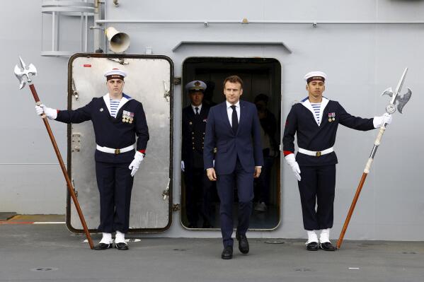 French President Emmanuel Macron walks on the deck of the amphibious helicopter carrier Dixmude docked in the French Navy base of Toulon, southern France, Wednesday, Nov. 9, 2022. Emmanuel Macron is to unveil the country's military strategy through the end of the decade for his nuclear-armed country, in the midst of Russia's war in Ukraine. (Eric Gaillard, Pool via AP)
