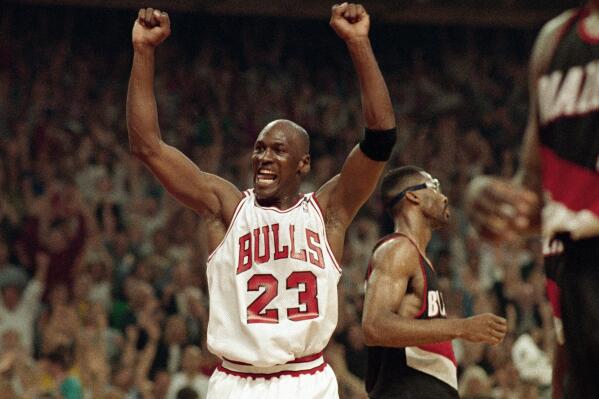 FILE - Michael Jordan celebrates the Chicago Bulls win over the Portland Trail Blazers in the NBA Finals in Chicago, on June 14, 1992. (AP Photo/John Swart, File)