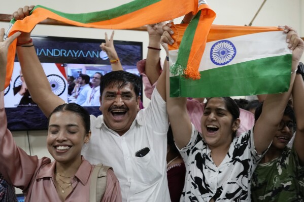 Indians celebrate the successful landing of Chandrayaan-3, or “moon craft” in Sanskrit, at the Nehru Planetarium in New Delhi, India, Wednesday, Aug. 23, 2023. (AP Photo/Manish Swarup)