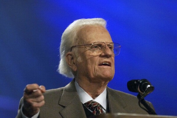 FILE - The Rev. Billy Graham addresses a gathering of about 40,000 people at Bulldog Stadium at Fresno State University in Fresno, Calif., Thursday, Oct. 11, 2001. A statue of the late Rev. Billy Graham set to stand inside the U.S. Capitol to represent North Carolina will be unveiled next week in a ceremony. (Mark Crosse/The Fresno Bee via Ǻ, File)