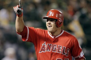 
              FIEL - In this April 3, 2017, file photo, Los Angeles Angels' Mike Trout celebrates after hitting a two-run home run off Oakland Athletics' Kendall Graveman in the third inning of a baseball game in Oakland, Calif. A person familiar with the negotiations tells The Associated Press Tuesday, March 19, 2019, that Trout and the Angels are close to finalizing a record $432 million, 12-year contract that would shatter the record for the largest deal in North American sports history. (AP Photo/Ben Margot, File)
            