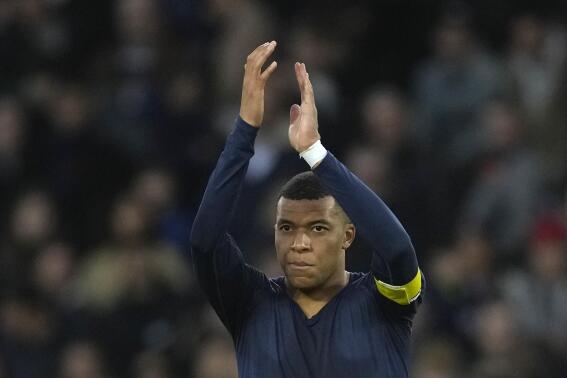 PSG's Kylian Mbappe applauds fans at the end of the French League One soccer match between Paris Saint-Germain and Rennes at the Parc des Princes in Paris, Sunday, March 19, 2023. (AP Photo/Christophe Ena)