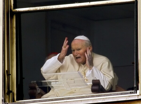 Pope John Paul II appears at a window of his rooms of the 10th floor of Rome's Gemelli Polyclinic Hospital, Sunday, March 13, 2005. (AP Photo/Lionel Cironneau, File)