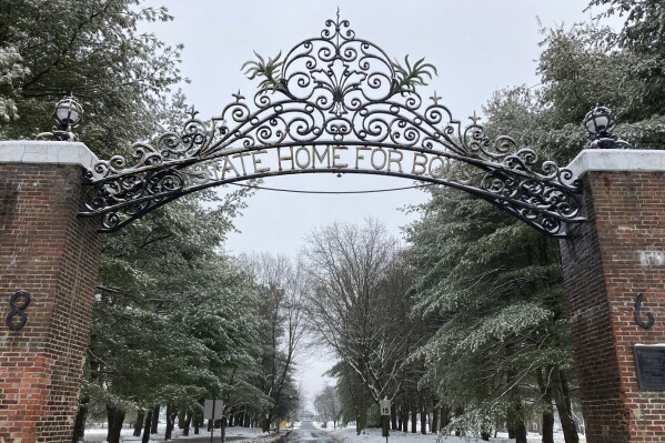 The gate outside the New Jersey Training School carries a bygone name for the facility, Tuesday, Jan. 16, 2024, in Monroe Township, N.J. The New Jersey youth detention center let a “culture of abuse,” in which staff sexually abused boys, endure for decades, according to a lawsuit filed Wednesday, Jan. 17 in state Superior Court by 50 men who lived at the facility. (AP Photo/Mike Catalini, File)