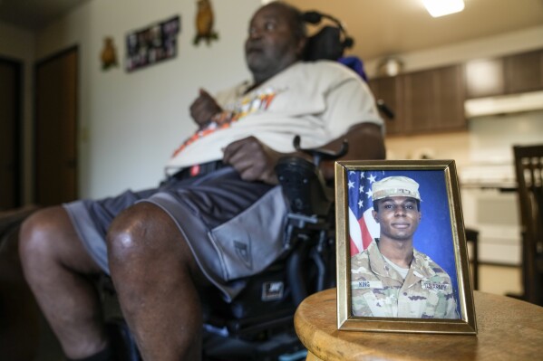 A portrait of American soldier Travis King is displayed as his grandfather, Carl Gates, talks about his grandson Wednesday, July 19, 2023, in Kenosha, Wis. Pvt. King bolted into North Korea while on a tour of the Demilitarized Zone on Tuesday, July 18, a day after he was supposed to travel to a base in the U.S. (AP Photo/Morry Gash)