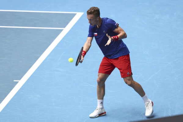 Jiri Lehecka of the Czech Republic hits a return to Novak Djokovic of Serbia during the United Cup tennis tournament in Perth, Australia, Tuesday, Jan. 2, 2024. (AP Photo/Trevor Collens)