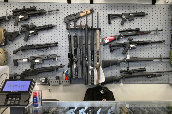 FILE - Firearms are displayed at a gun shop in Salem, Ore., Feb. 19, 2021. An Oregon judge will decide during a trial starting Monday, Sept. 18, 2023 whether a gun control law approved by voters last year is lawful under the state constitution. (AP Photo/Andrew Selsky, File)