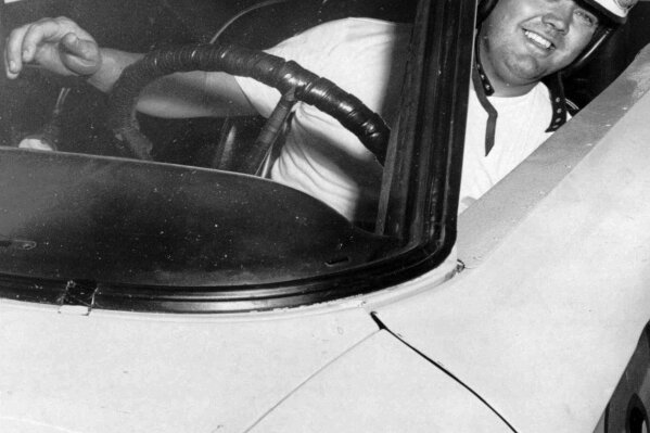 FILE - In this June 3, 1964, file photo, Junior Johnson peers from his car after winning the pole position for the Dixie 400 stock car race at Atlanta International Raceway in Atlanta. Johnson, who won 50 NASCAR Cup Series races as a driver and 132 as an owner and was part of the inaugural class inducted into the NASCAR Hall of Fame in 2010, has died at 88. (AP Photo/File)