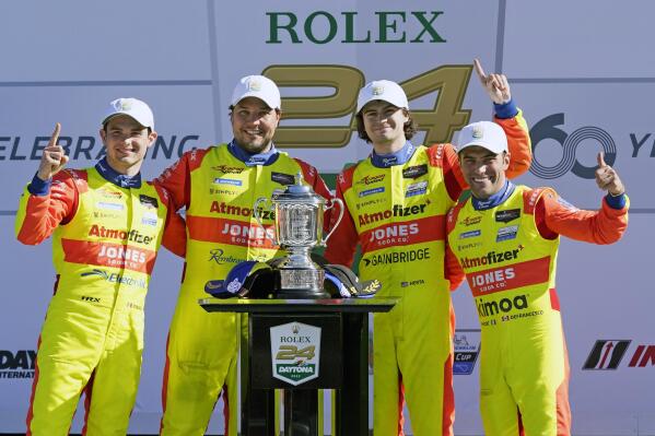 Winners of the LeMans Prototype 2 class in the Rolex 24 hour auto race, from left to right, Mexico's Patricio O'Ward, Eric Lux, Devlin Defrancesco and Cotlon Herta pose at Daytona International Speedway, Sunday, Jan. 30, 2022, in Daytona Beach, Fla. (AP Photo/John Raoux)