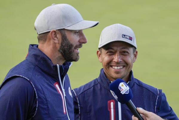 Team USA's Xander Schauffele and Team USA's Dustin Johnson smile after winning their four-ball match the Ryder Cup at the Whistling Straits Golf Course Friday, Sept. 24, 2021, in Sheboygan, Wis. (AP Photo/Ashley Landis)