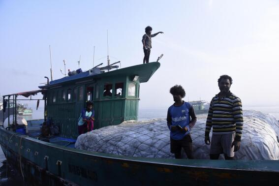 Fisherman work on a boat on March 3, 2023, in Kochi, Kerala state, India. The India Meteorological Department as well as the state of Kerala have increased infrastructure for cyclone warnings since Cyclone Ockhi in 2017, which killed about 245 fishermen out at sea. (AP Photo/Satheesh AS)