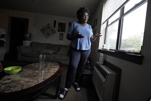 Bobbie Boyd talks about this summer's heat in her apartment which she shares with her 15-year-old grandson Jeremiah Williams Wednesday, Aug. 9, 2023, in Fayetteville, Ark. On a fixed income, Boyd sacrifices meals, health care, and car insurance among other necessities to pay rent and keep cool in the midst of this summer's prolonged heat waves. (AP Photo/Charlie Riedel)