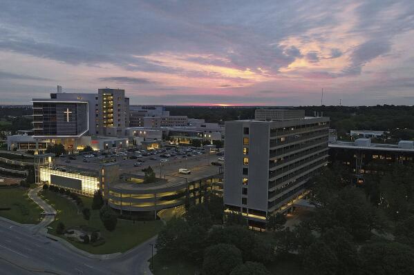 The sun rises over the St. Francis Hospital campus, Thursday, June 2, 2022, in Tulsa, Okla. Authorities say a gunman carrying a rifle and handgun killed four people at a Tulsa medical building on the hospital campus Wednesday. The gunman has not been identified but police say he died of an apparent self-inflicted gunshot wound. (Mike Simons/Tulsa World via AP)