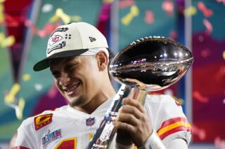 FILE -Kansas City Chiefs quarterback Patrick Mahomes (15) holds the trophy after their win against the Philadelphia Eagles in the NFL Super Bowl 57 football game, Sunday, Feb. 12, 2023, in Glendale, Ariz. For every example such as Kansas City's move to trade up for two-time MVP Patrick Mahomes in 2017 or Buffalo's decision the next year to move up for franchise quarterback Josh Allen, there are misses. (AP Photo/Matt Slocum, File)