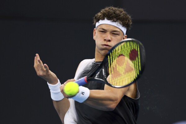 Ben Shelton of the U.S. plays a shot in his match against Roman Safiullin of Russia during the Brisbane International tennis tournament in Brisbane, Australia, Monday, Jan. 1, 2024. (AP Photo/Tertius Pickard)
