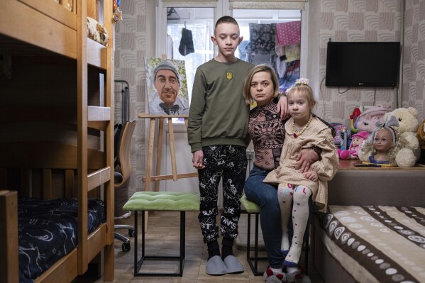 Natalia Sheleshei, 39, with her children Yehor, 12, and Anastasia, 5, wait for the return of Serhii at their apartment in Kyiv, Ukraine on Feb. 12, 2024. Serhii Sheleshei, 49, a Ukrainian serviceman went missing with three of his comrades during fighting at the frontline near Zaitseve, Donetsk region, on Oct. 12, 2022. 