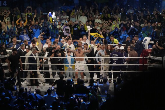 Ukraine's Oleksandr Usyk celebrates after beating Britain's Daniel Dubois during their world heavyweight title fight at Tarczynski Arena in Wroclaw, Poland, Sunday, Aug. 27, 2023. Oleksandr Usyk defends his WBC, IBF and WBA heavyweight titles for the first time in a year when he faces hard-hitting British challenger Daniel Dubois in a clash of styles. (AP Photo/Czarek Sokolowski)