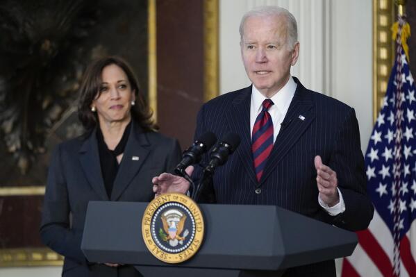 President Joe Biden speaks before signing the Consolidated Appropriations Act for Fiscal Year 2022 in the Indian Treaty Room in the Eisenhower Executive Office Building on the White House Campus in Washington, Tuesday, March 15, 2022. Vice President Kamala Harris listens at left. (AP Photo/Patrick Semansky)