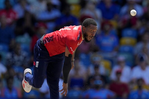 England's Chris Jordan bowls the delivery to get a hat-trick by dismissing United States' Saurabh Nethralvakar during the ICC Men's T20 World Cup cricket match between the United States and England at Kensington Oval in Bridgetown, Barbados, Sunday, June 23, 2024. (AP Photo/Ricardo Mazalan)