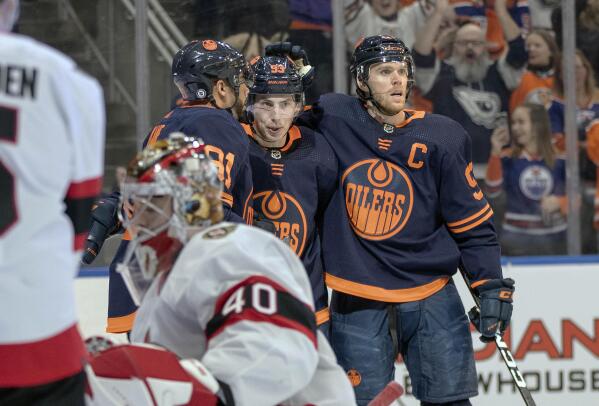 Edmonton Oilers' Evander Kane (91), Ryan Nugent-Hopkins (93) and Connor  McDavid (97) celebrate a goal against the Ottawa Senators during the second  period of an NHL hockey game in Edmonton, Alberta, Friday