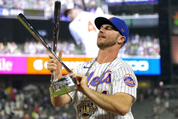 National League's Pete Alonso, of the New York Mets, holds the champions trophy after winning the MLB All Star baseball Home Run Derby, Monday, July 12, 2021, in Denver. (AP Photo/David Zalubowski)
