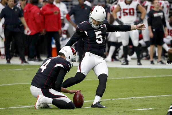 FILE - In this Sunday, Oct. 13, 2019 file photo, Arizona Cardinals kicker Zane Gonzalez (5) kicks a field goal as punter Andy Lee (4) holds against the Atlanta Falcons during the first half of an NFL football game in Glendale, Ariz. Zane Gonzalez has taken over as the Carolina Panthers kicker after the team released Ryan Santoso, Wednesday, Sept. 15, 2021. (AP Photo/Ross D. Franklin)