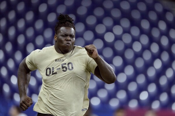 FILE - Georgia offensive lineman Amarius Mims runs the 40-yard-dash during the NFL football scouting combine March 3, 2024, in Indianapolis. The Cincinnati Bengals chose Mims in the first round of the NFL draft Thursday night, April 25. (AP Photo/Charlie Riedel, File)