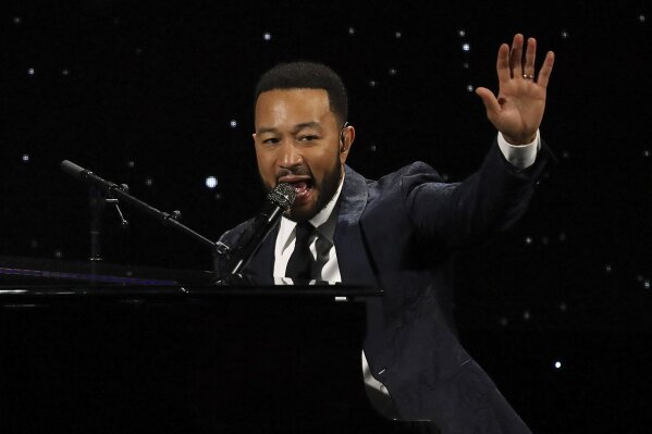 FILE - This March 5, 2020 file photo shows John Legend performing at The Alliance for Children's Rights 28th Annual Dinner in Beverly Hills, Calif. The spreading coronavirus might have canceled several touring performances from A-list musical artists, but those acts have found a new venue to sing: their living rooms. Legend, Bono, Coldplay’s Chris Martin, Pink, John Mayer, Keith Urban and more have held virtual concerts from their homes as the world continues to practice social distancing to slow the spread of the virus. (Photo by Willy Sanjuan/Invision/AP, File)