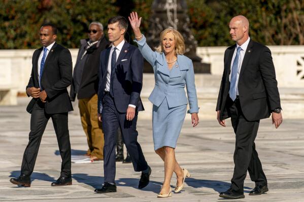 Mississippi Attorney General Lynn Fitch, center right, accompanied by Mississippi Solicitor General Scott Stewart, center left, waves to supporters as they walk out of of the U.S. Supreme Court, Wednesday, Dec. 1, 2021, in Washington, after the court heard arguments in a case from Mississippi, where a 2018 law would ban abortions after 15 weeks of pregnancy, well before viability. (AP Photo/Andrew Harnik)