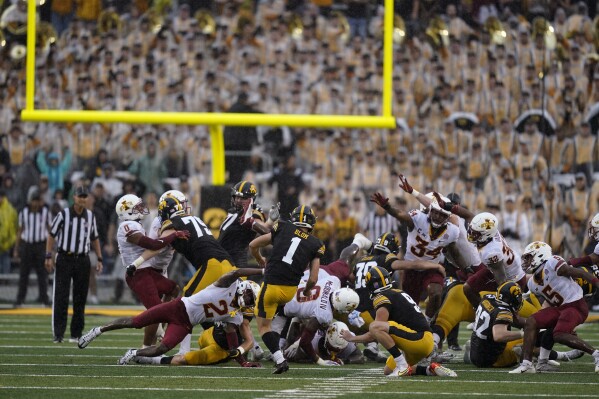 FILE - Iowa place kicker Aaron Blom (1) misses a field goal at the end of an NCAA college football game against Iowa State, Saturday, Sept. 10, 2022, in Iowa City, Iowa. Iowa State won 10-7. A former walk-on kicker at the University of Iowa was charged Wednesday, Aug. 2, 2023, in connection with wagering on Hawkeyes sports events — one day after Iowa State quarterback Hunter Dekkers was accused of committing the same offense. The criminal complaint filed in Johnson County said Aaron Blom, who was on the Iowa roster from 2020-22, tampered with records related to an Iowa Criminal Division investigation into sports gambling. (AP Photo/Charlie Neibergall, File)