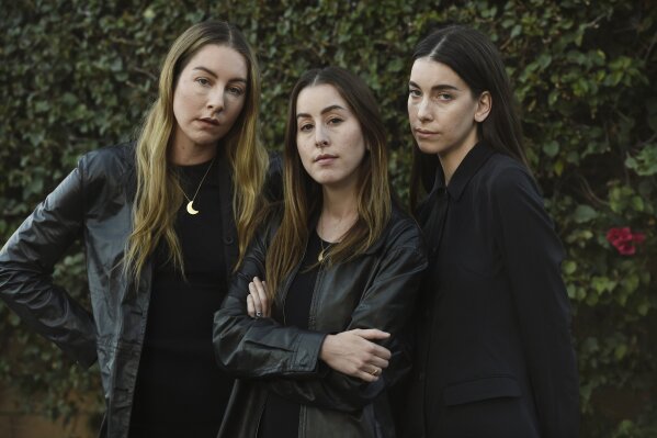 Sisters, from left, Este, Alana and Danielle Haim of the band HAIM pose together for a portrait in Los Angeles on Feb. 22, 2021. (AP Photo/Chris Pizzello)