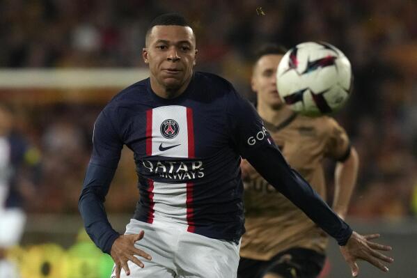 PSG's Kylian Mbappe races after the ball during the French League One soccer match between Lens and Paris Saint-Germain at the Bollaert stadium in Lens, France Sunday, Jan. 1, 2023 (AP Photo/Thibault Camus)