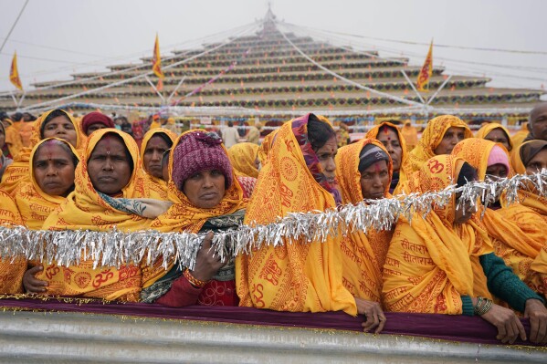 Hindu devotees participate in a religious ritual at a camp erected for people arriving to attend the Monday opening of a temple dedicated to Hindu deity Lord Ram in Ayodhya, India, Friday, Jan. 19, 2024.  (AP Photo/Rajesh Kumar Singh)
